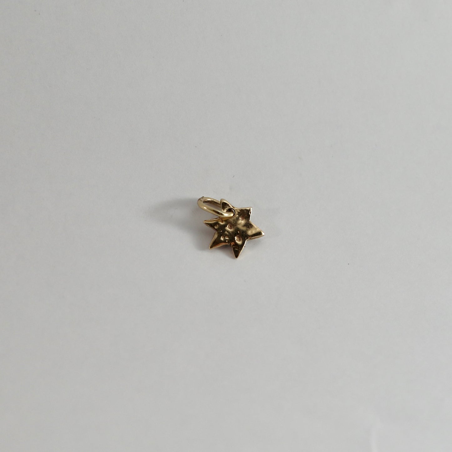 Gold star charm