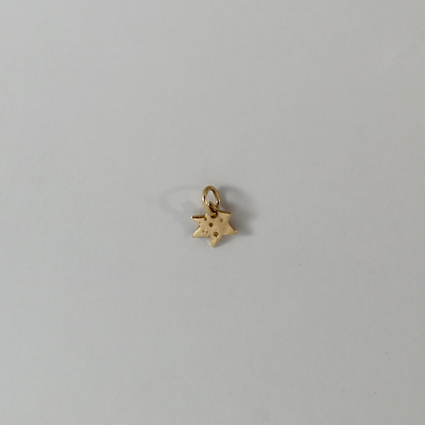 Gold star charm